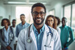 © vefimov - male doctor smiling and standing in a corridor. he is likely to be working at a medical institution or hospital and may relate to themes of healthcare, medicine, or well-being