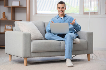 Sticker - Young man with laptop video chatting at home