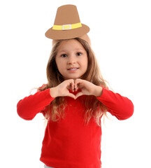 Wall Mural - Cute little girl in paper hat making heart gesture on white background. Thanksgiving Day celebration