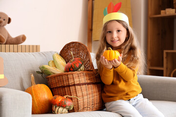 Wall Mural - Cute little girl with pumpkins at home. Thanksgiving Day celebration