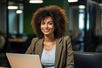 Poster - Woman is sitting in front of laptop computer. This image can be used to depict concepts such as remote work, online communication, or technology in everyday life