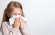Sick girl blowing his nose with flu cough on isolated white with copy space background