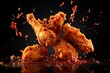 Freeze motion of flying golden brown crispy fried chicken on black background Levitating food