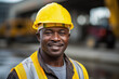 Middle aged African male builder worker in hard hat, man at construction site
