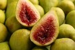 Halves of green fig on fresh fruits, closeup