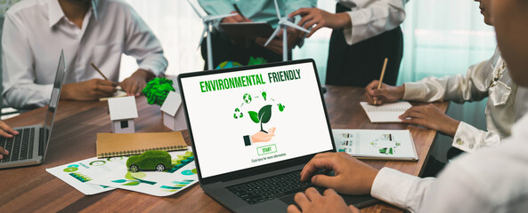 Business people in green corporate company planning eco-friendly and environmental conservative to reduce CO2 and implement net zero policy in meeting room with eco idea on laptop screen. Trailblazing
