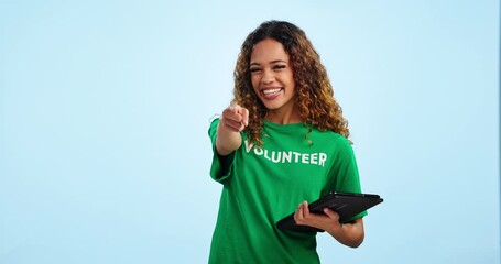 Poster - Woman volunteering, tablet and pointing at you to sign up online for charity and help on blue background. Community service, donation on nonprofit site and choice, registration and activism in studio