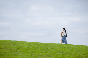 Poster - Woman with her dachshund dog walking in the park