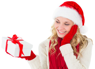 Sticker - Digital png photo of happy caucasian woman with santa hat holding gift on transparent background