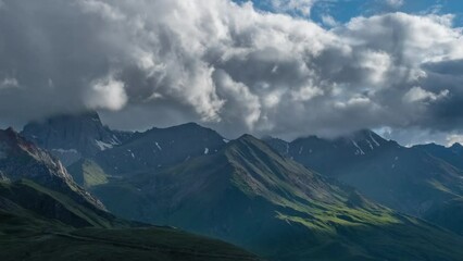 Wall Mural - beautiful landscape with mountains and clouds in dusk, caucasus, russia, zoom out timelapse 4k