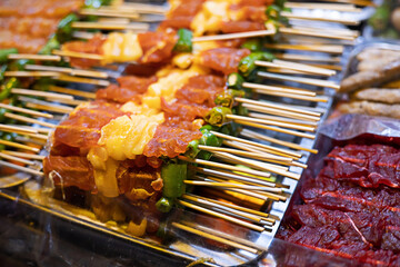 Barbecued pork skewers are sold on the local streets of Thailand.