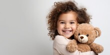 Child Hugs A Bear Doll On A White Background, Generative AI