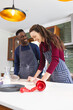 Happy diverse couple baking together in kitchen at home