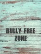 Blue old wood wall copy space background with text BULLY-FREE ZONE, anti bully policy , stop or reduce bullying, shame , abuse to create safe space in cyber neighborhood or school