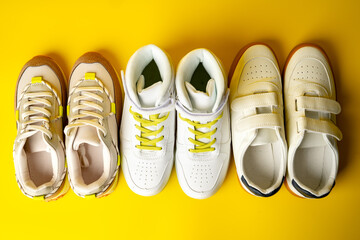 Wall Mural - Several pairs of fashion trendy sport shoes on yellow background