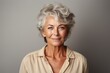 © leftmade - Senior woman portrait, mature grey haired beautiful smiling lady with neutral background, studio shooting