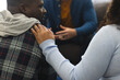 © WavebreakMediaMicro - Two african american male and female friends talking and supporting each other on therapy session