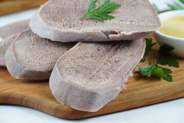 Wall Mural - Sliced boiled Beef Tongue Slices on Wooden Board with mustard