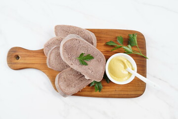 Wall Mural - Sliced boiled Beef Tongue Slices on Wooden Board with mustard