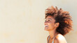 © BlazingDesigns - Stunning portrait of an african american black woman. Smiling beautiful afro girl. Curly black hair. Emotion concept. Copy space.