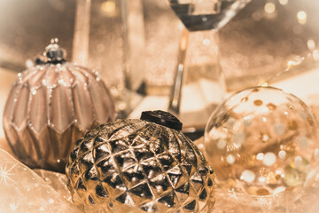 Wall Mural - Close-up of Christmas baubles on a table decorated for Christmas, warm gold colors