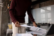 © Wavebreak Media - Midsection of african american casual businessman looking at documents at home office, copy space