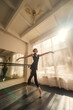 A beautiful Asian ballerina is training in a dance class. Vertical photo.