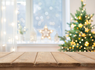 Wall Mural - empty table in front of christmas tree with decoration background