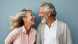 © standret - Beautiful gorgeous 50s mid age elderly senior model couple with grey hair laughing and smiling. Mature old man and woman close up portrait.