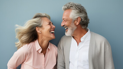beautiful gorgeous 50s mid age elderly senior model couple with grey hair laughing and smiling. matu