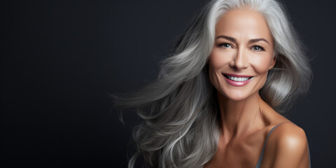 Wall Mural - Close up beautiful female with smooth healthy face skin. Gorgeous aging mature woman with long gray hair and happy smiling. Beauty and cosmetics skincare advertising concept