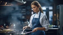 Portrait of chef woman preparing food in a professional kitchen