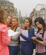 © fStop - Back View of Woman Standing in front of Teenage Girls