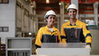© Nassorn - Hispanic industrial engineers in white helmet and safety jacket working in heavy metal engineering factory. Latin technician workers using tablet computer in metalwork manufacturing facility, portrait
