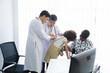 © Rakchanok - Ability of elderly employee working in hospital, elderly aging employment, Asian senior 60s specialist professor gvie advice working together with Hispanic Caucasian doctor consult child patient