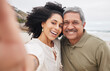 © Talia Mdlungu/peopleimages.com - Portrait, selfie of woman and mature father at beach on vacation, holiday or travel outdoor. Face, picture and dad with adult daughter at ocean for care, happy family bonding or smile together at sea