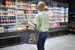 © Chanelle Malambo/peopleimages.com - Back, supermarket and grocery food with a woman customer shopping to purchase a product for retail spending. Store prices, shelf and choice with a consumer or shopper carrying a basket in an aisle