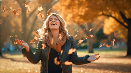 Wall Mural - Adult woman with arms outstretched enjoying nature in park. Fall season fashion park with yellow foliage maple leaves. Portrait of a adult woman in autumn.
