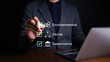 © Supatman - ESG environmental social governance strategy investment business concept. Businessman checking mark on checklist with checkmark on virtual screen. Sustainable and Ethical organization development.