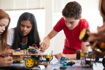 Students In After School Computer Coding Class Building And Learning To Program Robot Vehicle