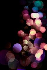 Wall Mural - colorful bokeh lights on a black background close-up. festive abstract background.