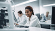 Beautiful young african american woman scientist wearing white coat in modern Medical Science Laboratory with Team of Specialists on background. Portrait of a female scientist working in a laboratory