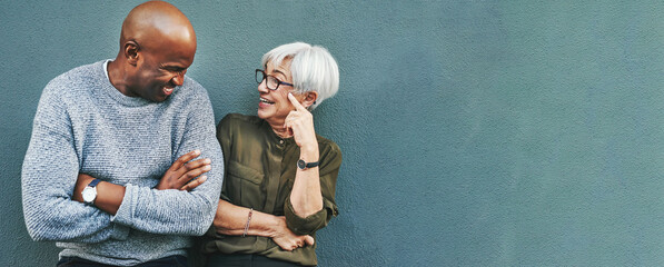 Business people, conversation and staff on wall background, planning and funny with mockup space. Black man, woman and workers with happiness, discussion and brainstorming with humor, joke and ideas