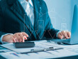 © MrPanya - Businessman uses laptop to analyze company growth, business growth arrow graph and future cost reduction. Development to achieve goals