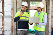 © offsuperphoto - workers or architects meeting and working on laptop computer at construction site