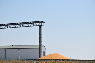 Poster - Pile of Corn by a Grain Elevator