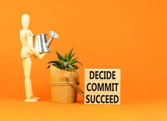 Wall Mural - Decide commit succeed symbol. Concept word Decide Commit Succeed on beautiful wooden block. Businessman model. Beautiful orange table background. Business decide commit succeed concept. Copy space.