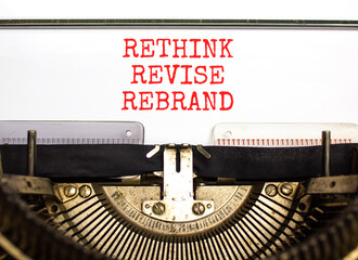 Rethink revise rebrand symbol. Concept word Rethink Revise Rebrand typed on retro typewriter. Beautiful white paper background. Business brand motivational rethink revise rebrand concept. Copy space.