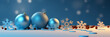 Blues baubles and snowflakes on a white floor with a blue blurred background.