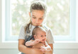 © Louis-Paul Photo - sister on bedroom with newborn son at home